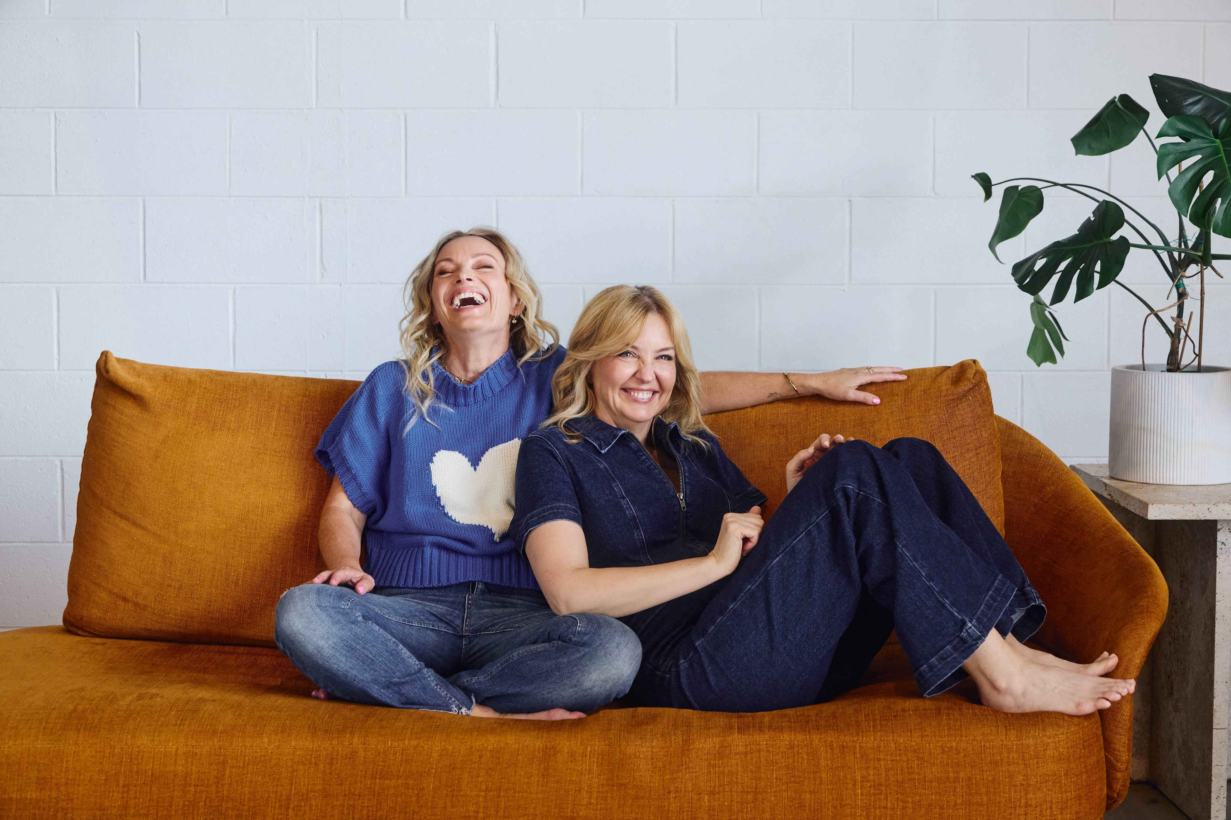 Eir Women Founders - Lisa Walker - Kate Guaran - Brown Couch - White wall - Green indoor plant