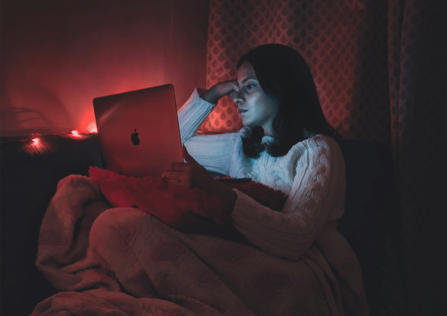 women in bed working on computer