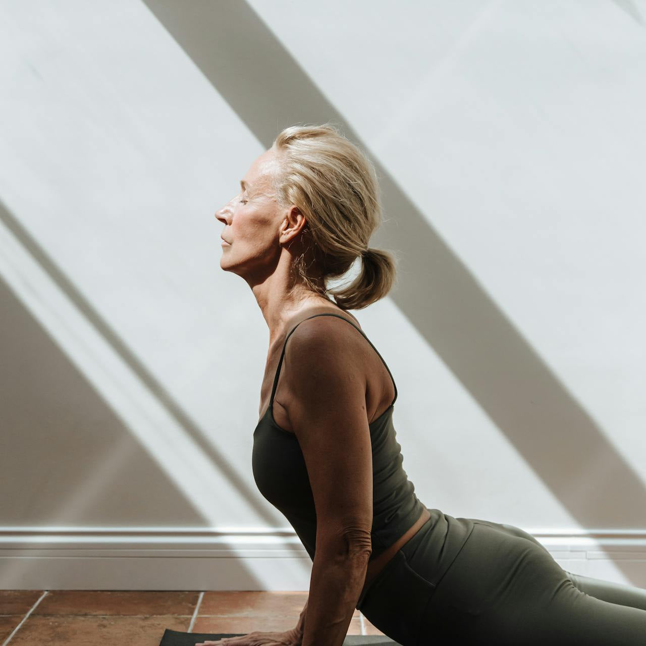 Woman over 40 stretching in workout clothes