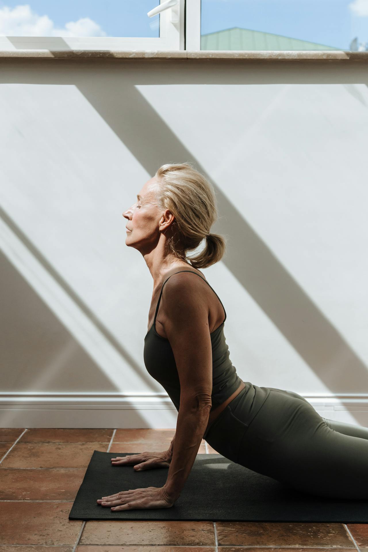 Woman over 40 stretching in workout clothes
