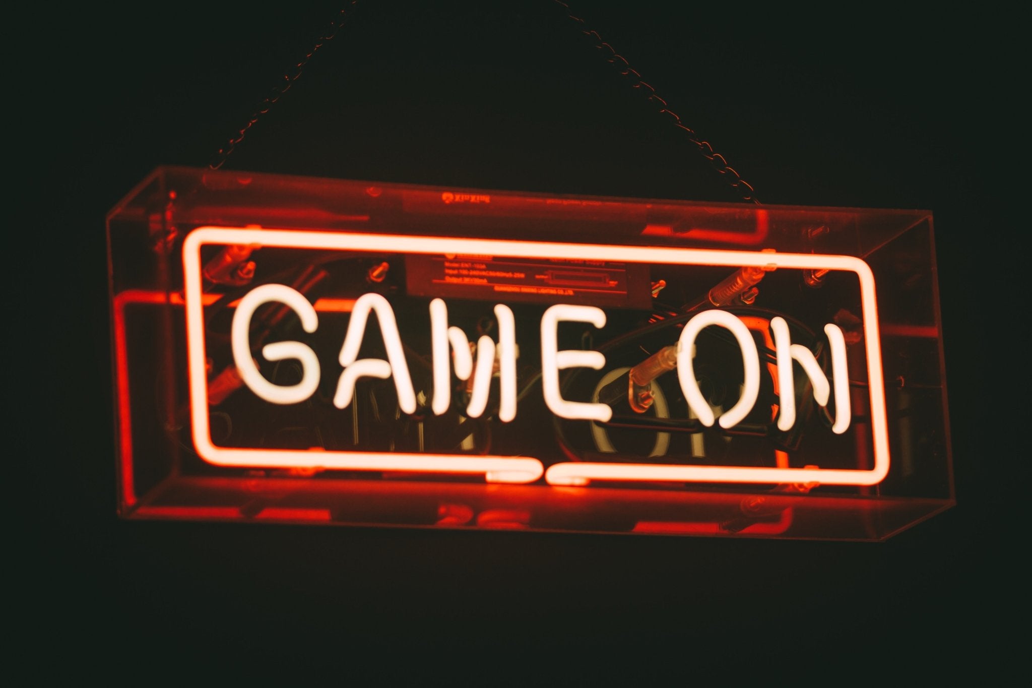 The words Game On in red neon lights and black background