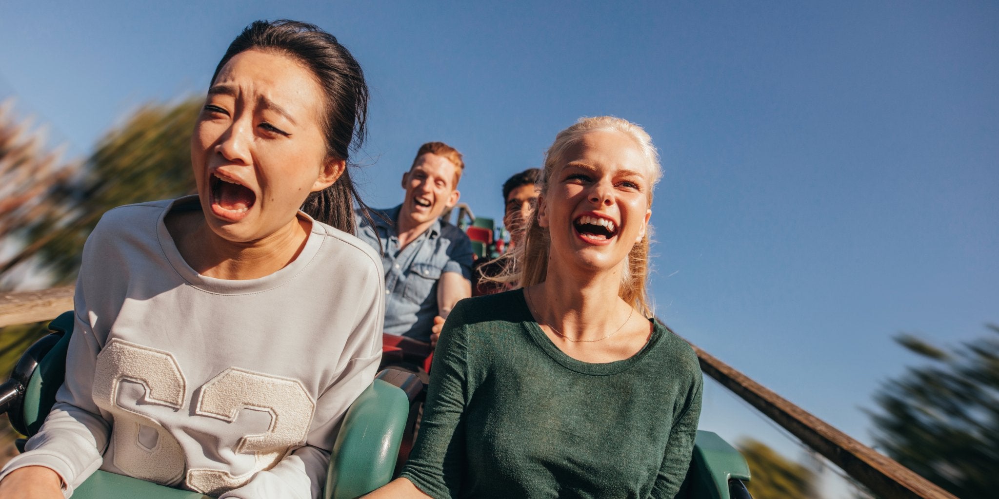 two women screaming on roller coaster