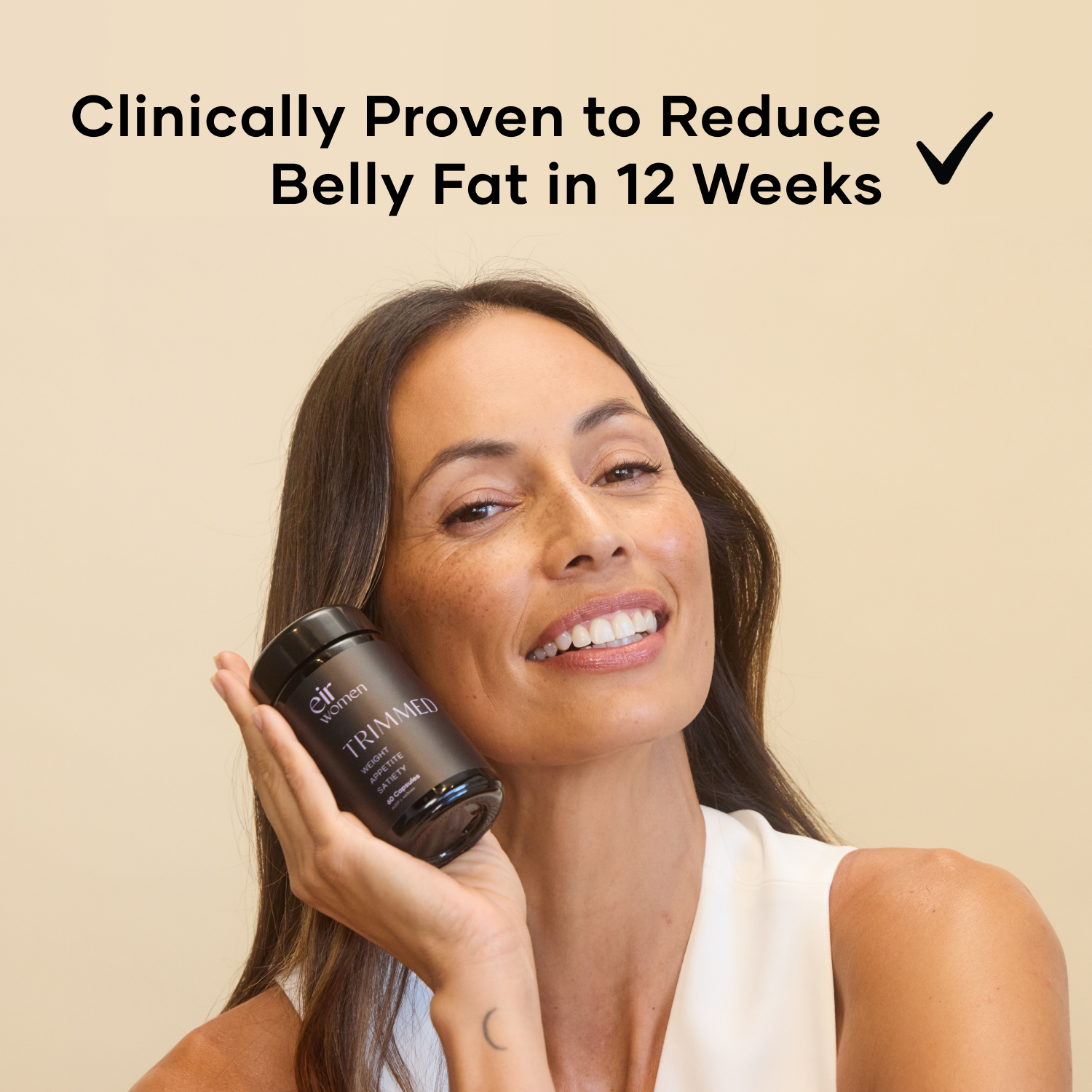 Woman holding a bottle of Trimmed Eir Supplement - Clinically proven to reduce belly fat in 12 weeks