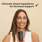 Woman holding a glass black bottle of Show Up Eir Supplement, For Energy, Stress, Brain Health
