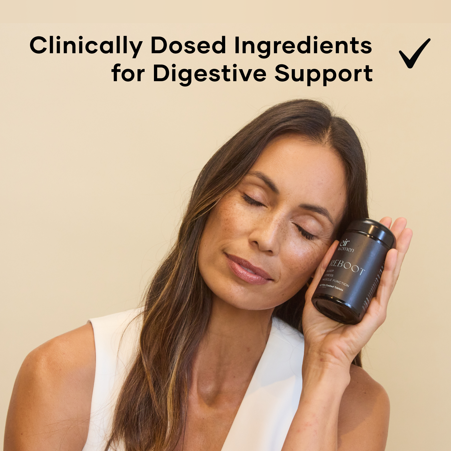 Woman with closed eyes holding a bottle of Reboot