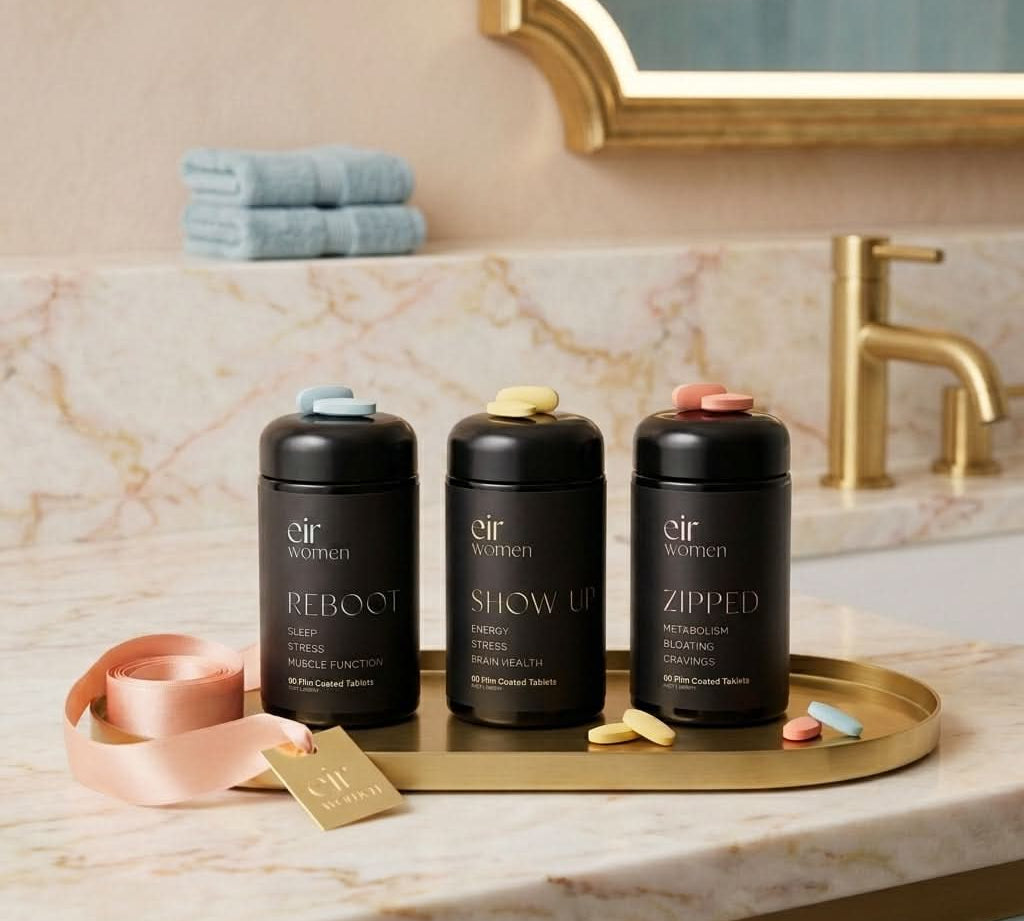 Three black containers labeled 'Reboot', 'Show Up', and 'Zipped' on a marble countertop with a mirror and towels in the background.